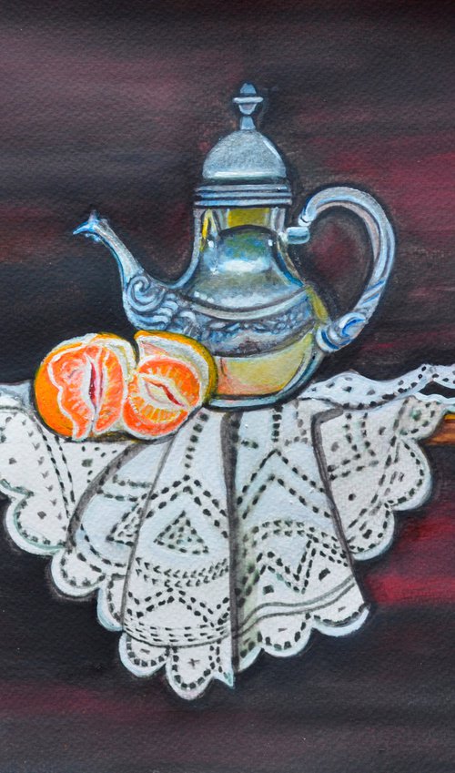 Still life with orange and teapot on lace by Manjiri Kanvinde