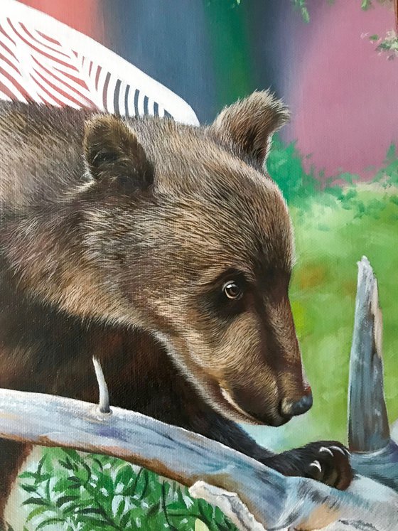 The bear-cub near the driftwood.