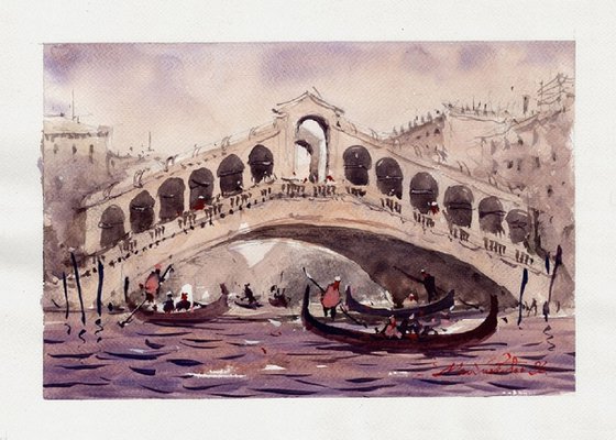 Gondola passes under Rialto Bridge.
