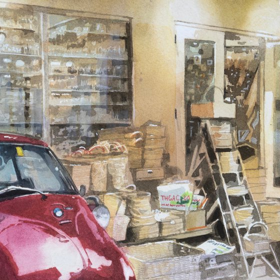 Red Vintage Car in Front of a General Store