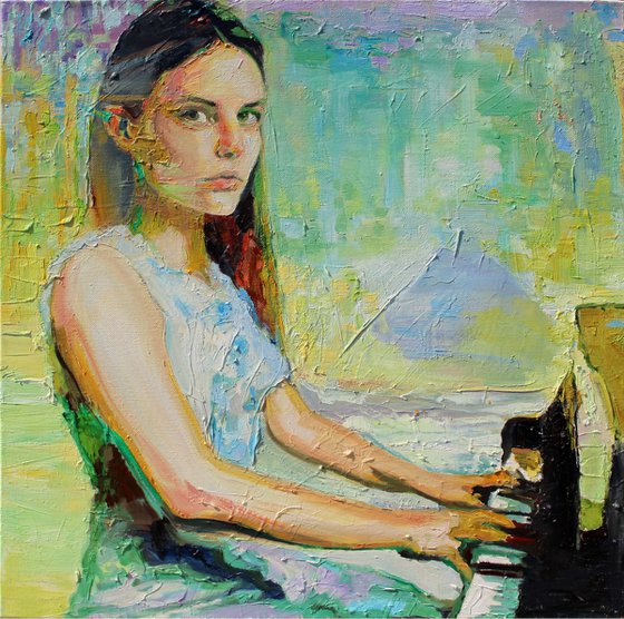 Girl sat at a piano
