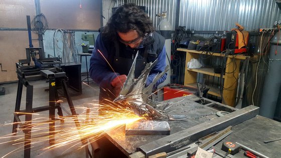 Brutalist welded iron sculpture star bird fueling the space around her  KLOSKA O romanian artist