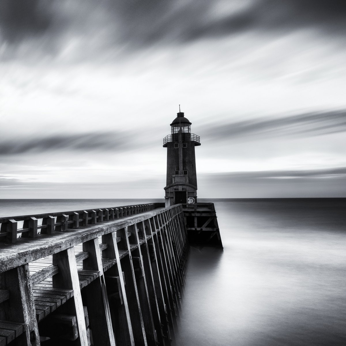 A lighthouse at the port by Karim Carella