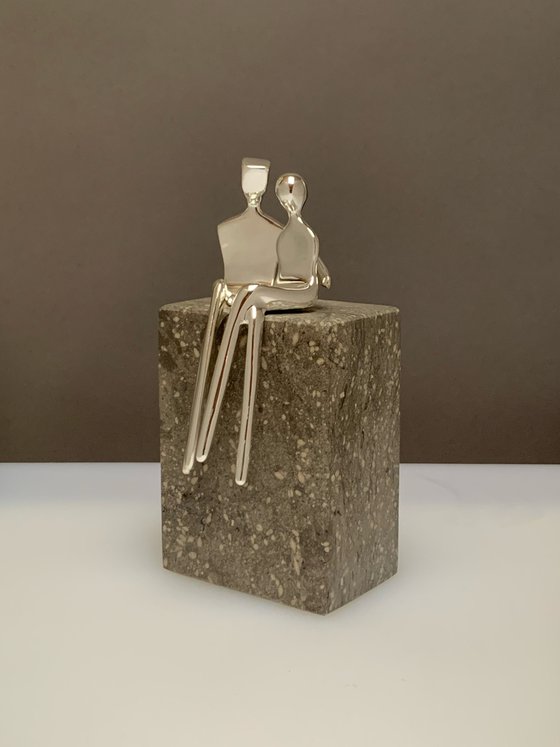 "Caress" a small  silver plated sculpture of a loving couple