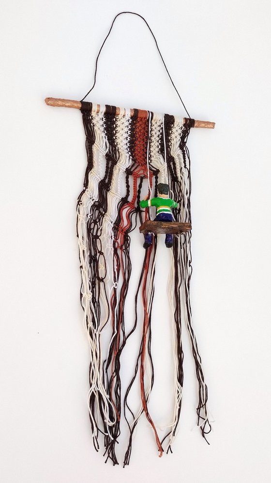 Boy on the macrame wall hanging