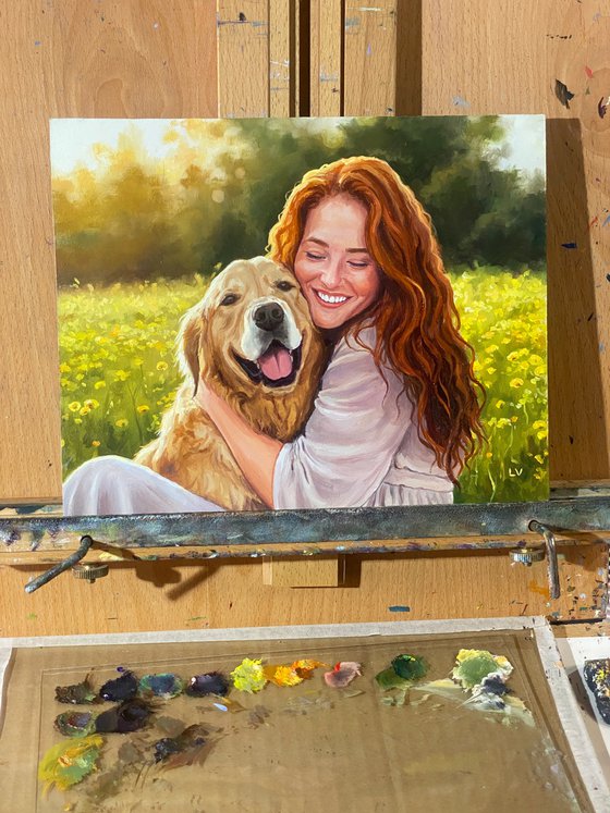 Smiling red-haired woman hugging a dog