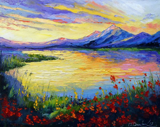 Poppies on the lake by the mountains