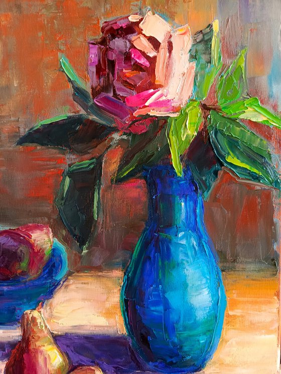 Red rose in a blue vase