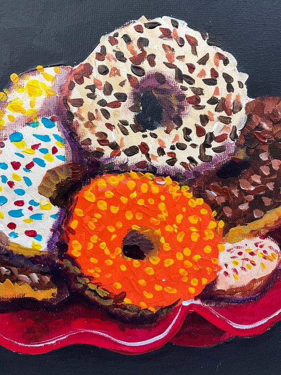 Colourful donuts in red dish