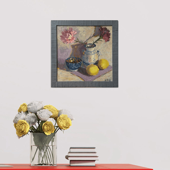Lemons and flowers with a vase