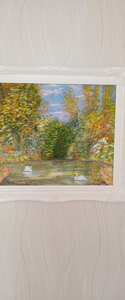 Swans on a serene forest lake by James Lancaster