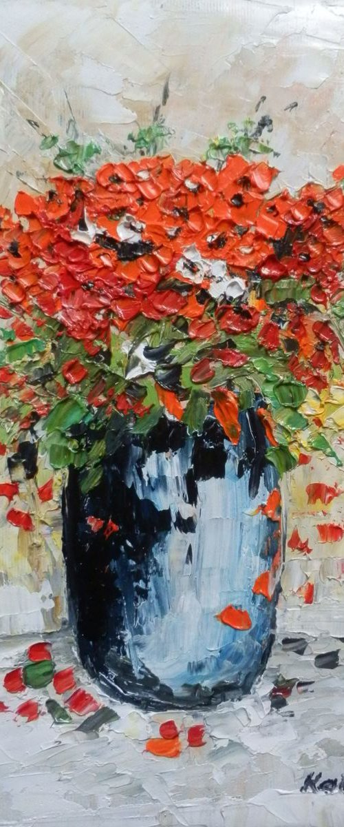 Red flowers in a bowl by Maria Karalyos