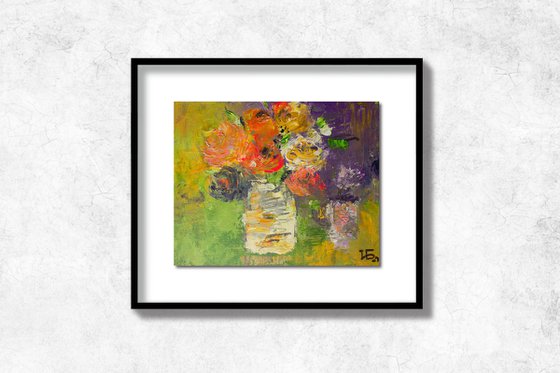 Small still life with bright colorful flowers in the white vase on green and lilac background