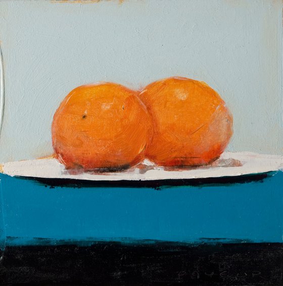 two oranges on blue