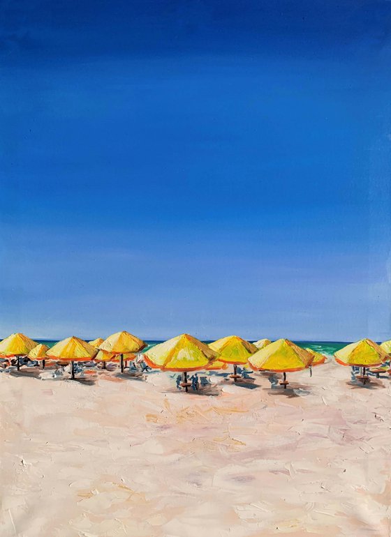 At the beach. Yellow parasols.