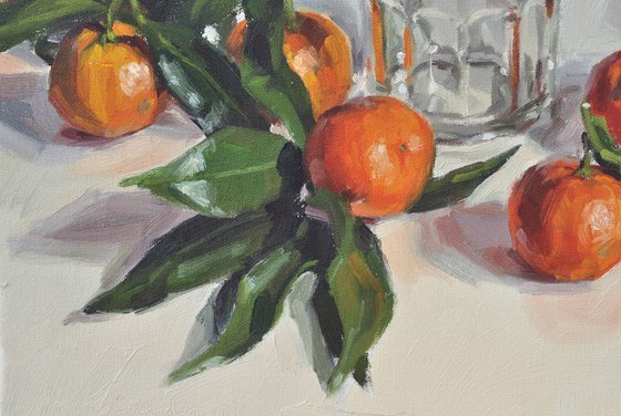 Clementines with leaves and old jam jar