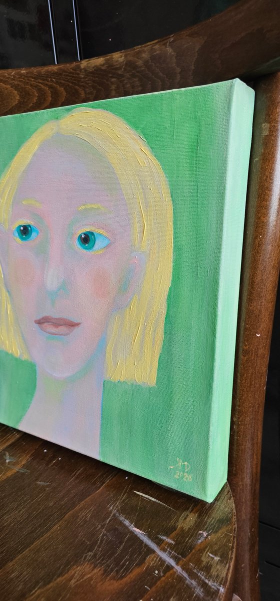 Young and blond soft green woman portrait