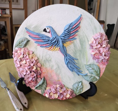 A Parrot in hydrangea, sculpture painting - round 3d landscape with macaw bird and flowers 30x30x3 cm by Irina Stepanova