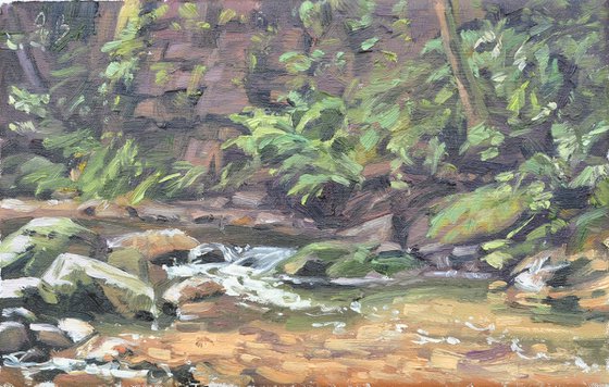 River at the foot of the cliff