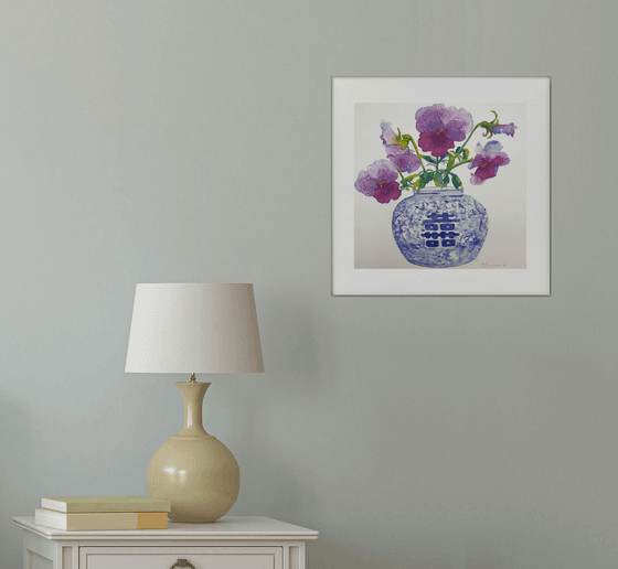 Purple pansies in a blue & white vase