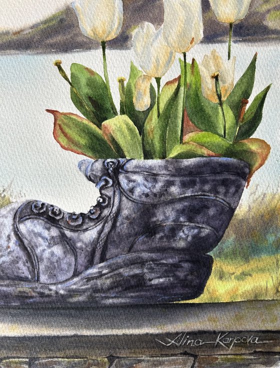 White tulips in old shoe planter sea view