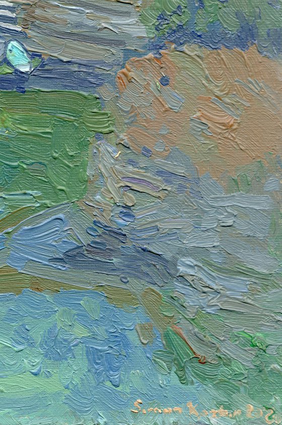 A lonely white sail gleams