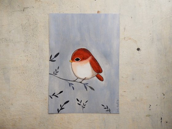 The small bird in red