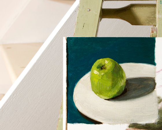 still life of fresh green apple on a blue background