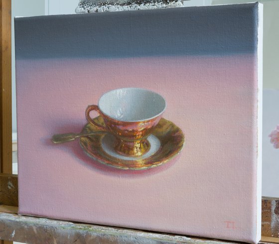 Coffee cup on pink tablecloth