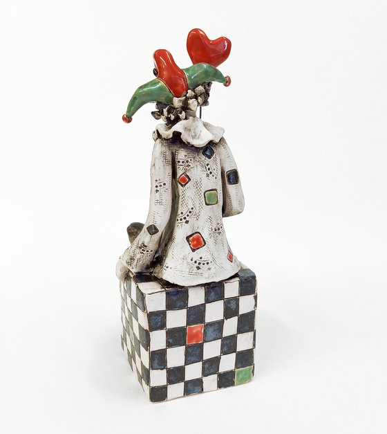 The Clown Sitting on a Chess Cube