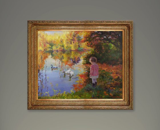 Girl and ducks, golden autumn