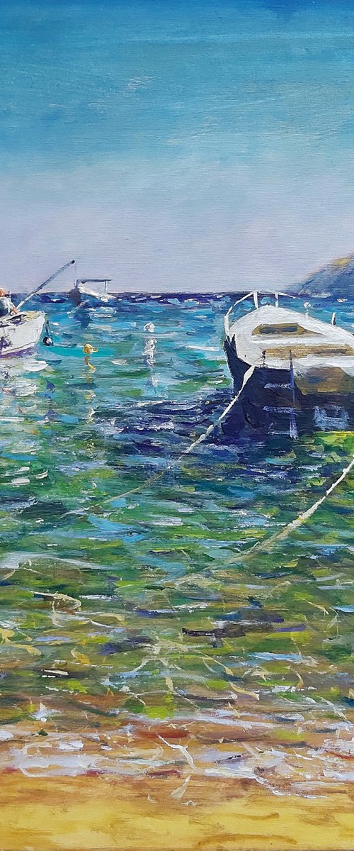 Three boats and  a fisherman by Dimitris Voyiazoglou