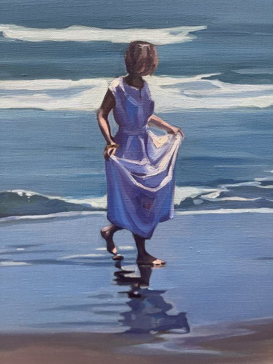 Walk by the ocean. Girl in a white dress