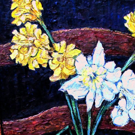 Daffodils in a stone pot on an old chair