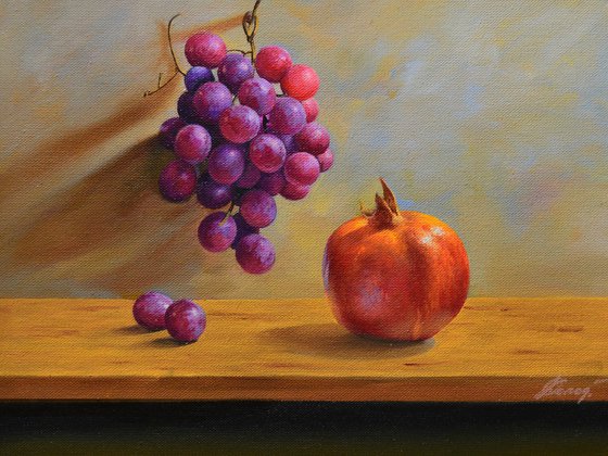 Still life with pomegranate and grapes