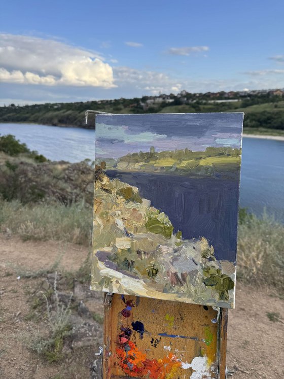 Riverbank Under Summer Sky