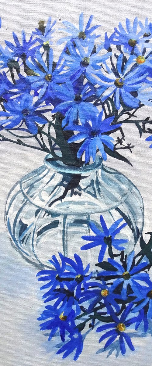 Blue Asters In A Glass Vase by Joseph Lynch