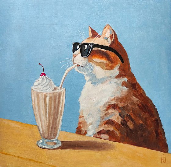 Cat drinking a milkshake