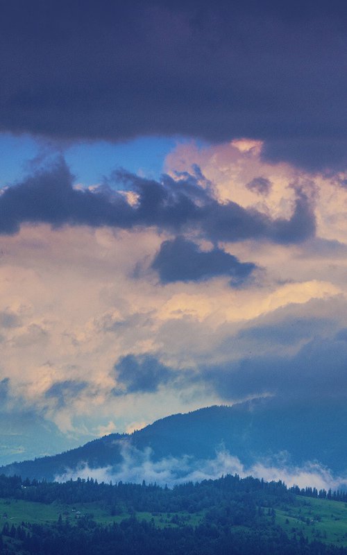 Waves of clouds over green mountains. by Valerix