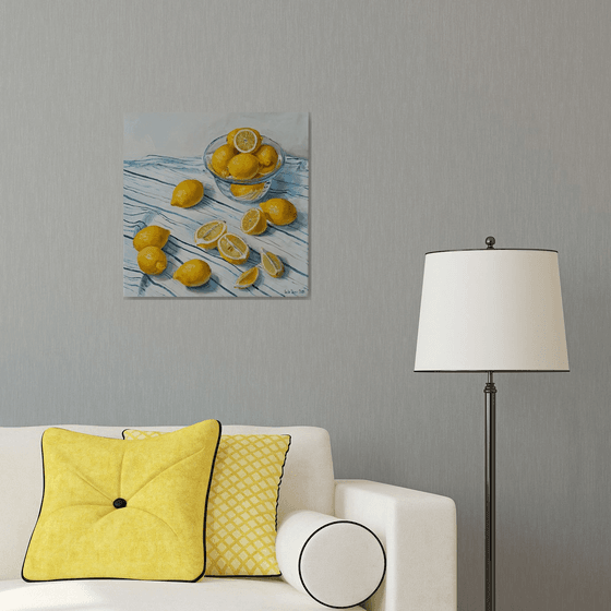 Lemons in glass bowl on stripen tablecloth