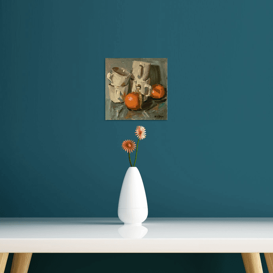 Stacked cups and oranges