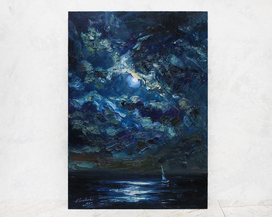 Night in the sea with moon and clouds