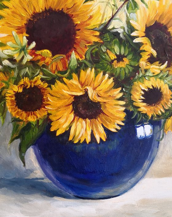 Sunflowers bouquet in a blue glass vase still life