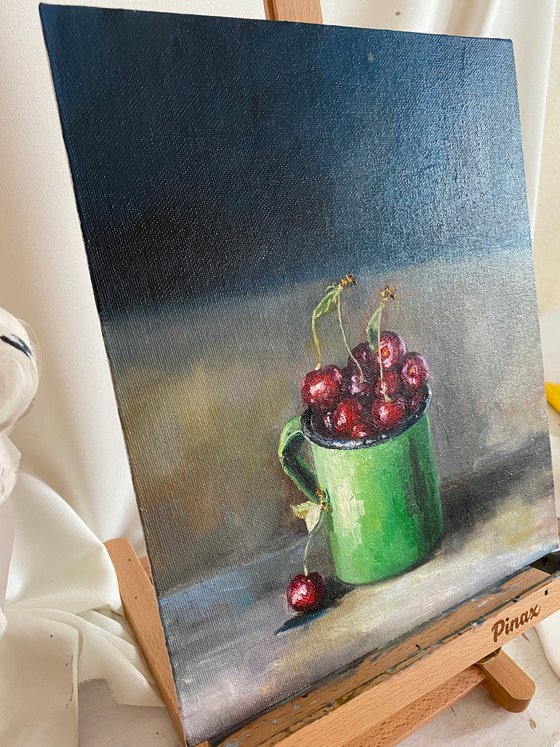 Cherries in a green cup