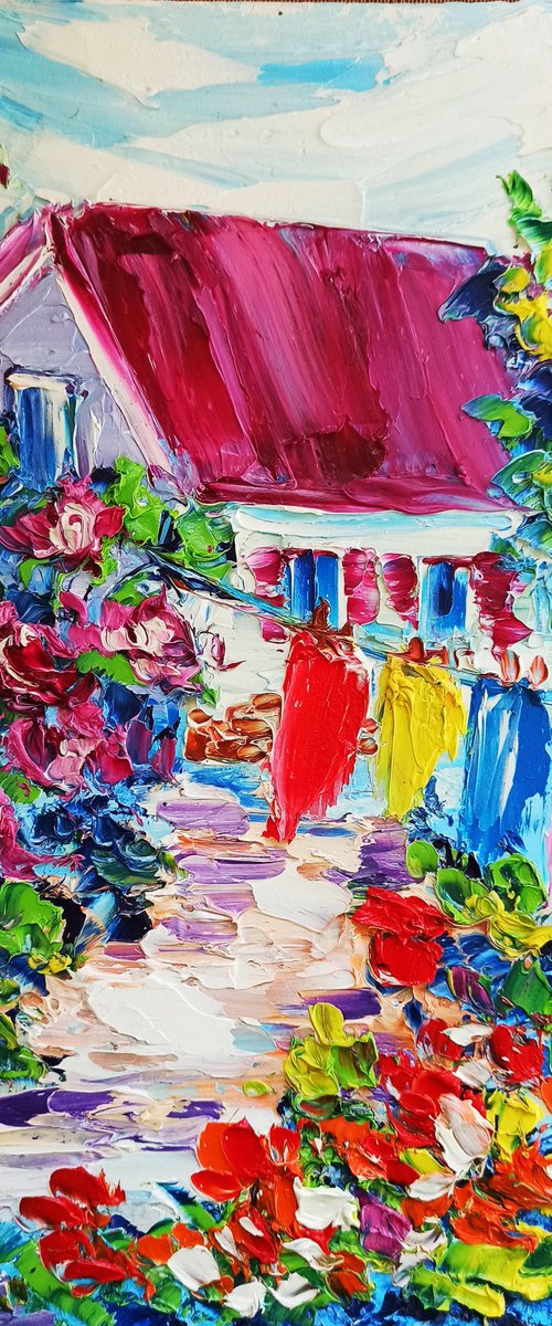 The laundry is drying between flowers near the house in village by Oksana Fedorova