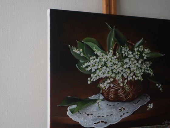 Lilies of the valley in rustic basket