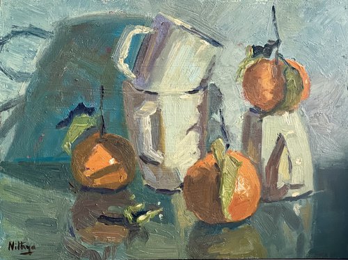 Oranges and white cups on blue by Nithya Swaminathan