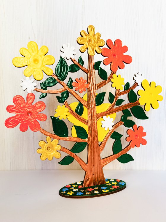 Baby tree with flowers. Fairytale fantasy tree, positive colorful sculpture