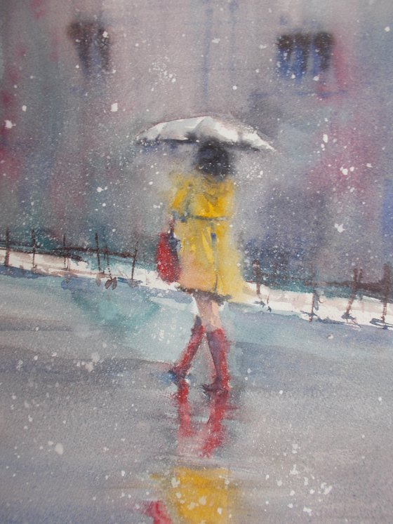 woman walking under the snow