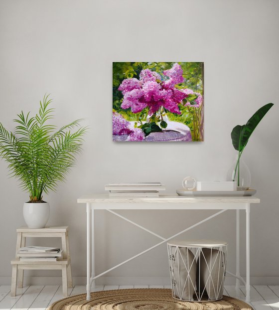 Lilac bouquet in a glass vase in the garden still life